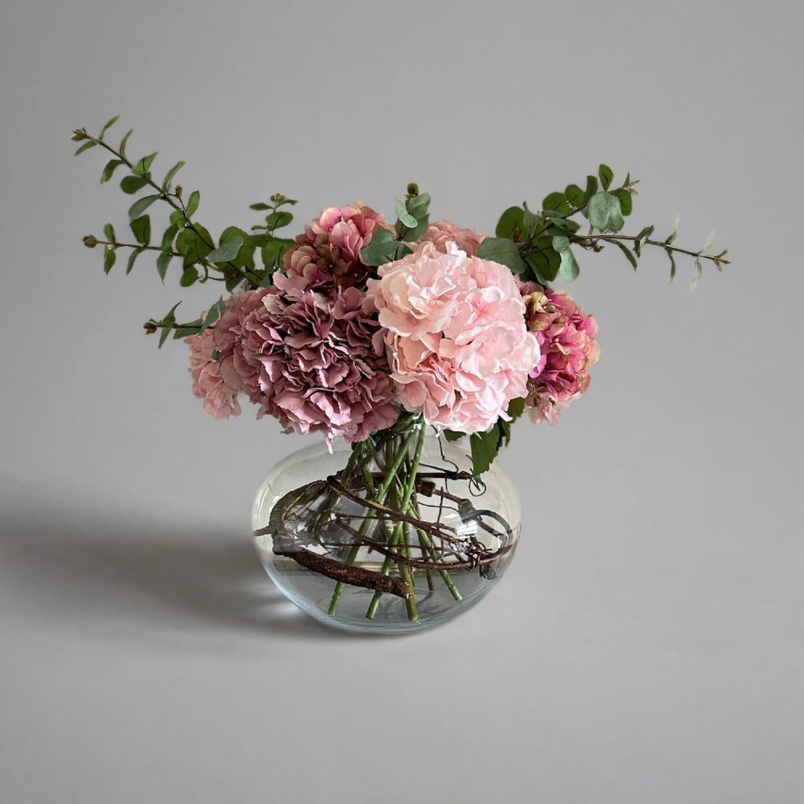 Hydrangeas and Eucalptus, with Willow twig wrapped around a Large Lipped Fish Bowl main product photo